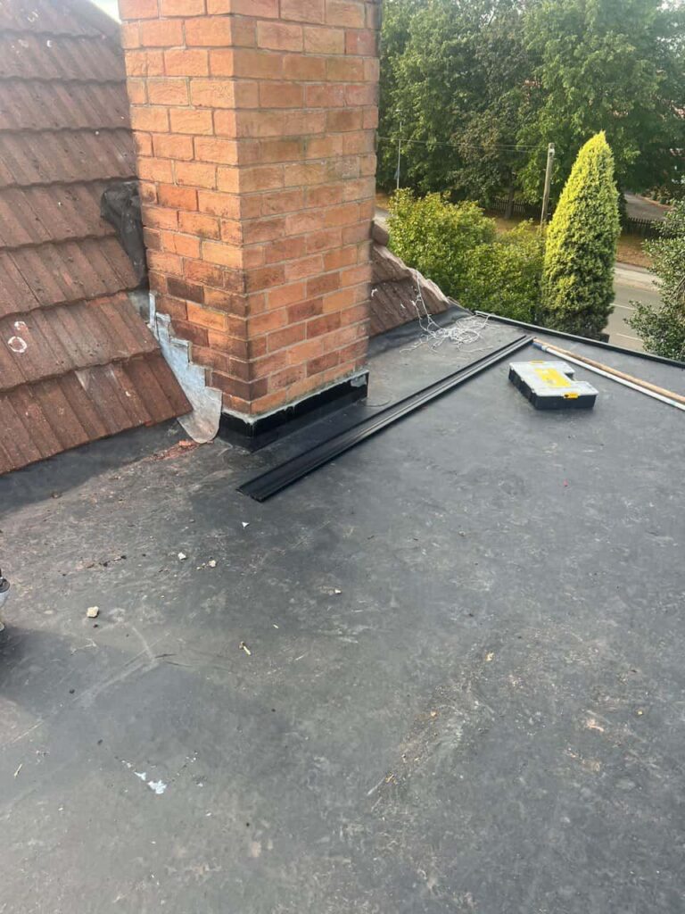This is a photo of a flat roof which has just been repaired, there is also a chimney stack and some leadwork has also been dressed. Works carried out by Greenhithe Roofing Repairs